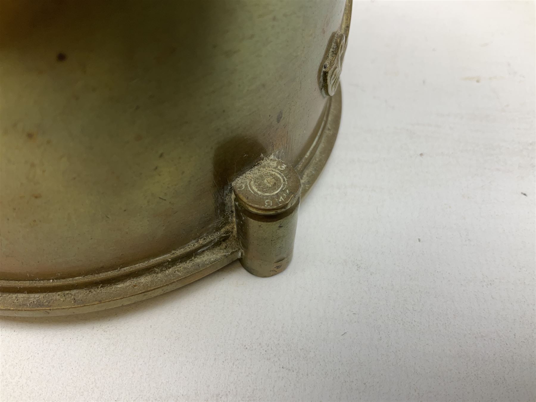 Trench Art - three WW2 brass shell case ashtrays, one mounted with Royal Artillery cap badge and button and one mounted with RA button; together with a pair of place name holders each formed from a Royal Artillery cap badge (5)