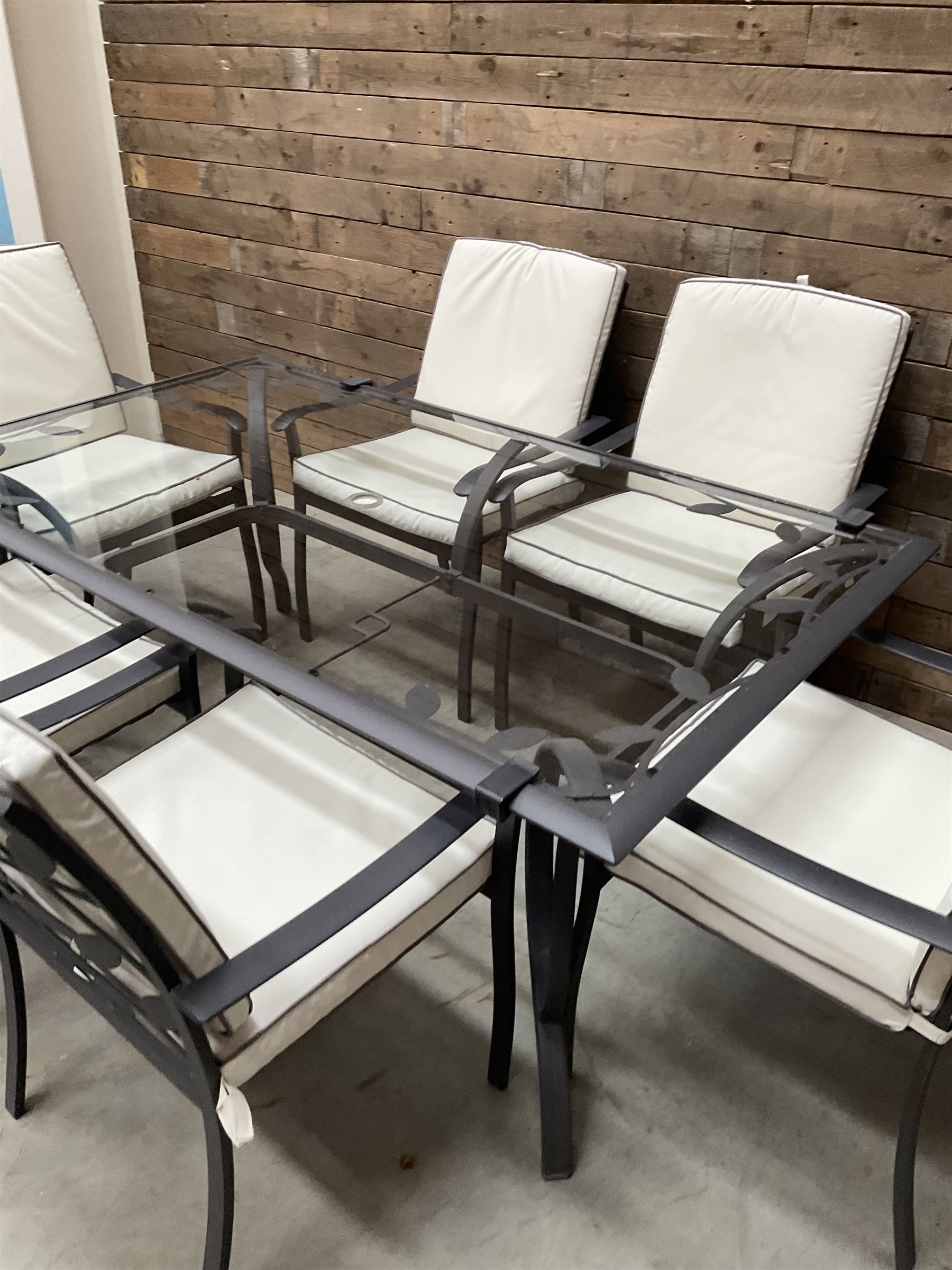 Metal framed garden table with glazed top (W170cm, D102cm, H71cm) and six armchairs with cushions 