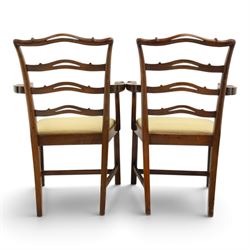 Pair of Georgian design Chippendale style mahogany elbow chairs, the pierced and waived ribbon ladder-back over scrolled arm terminals and yellow drop-in seats, on moulded and chamfered square supports