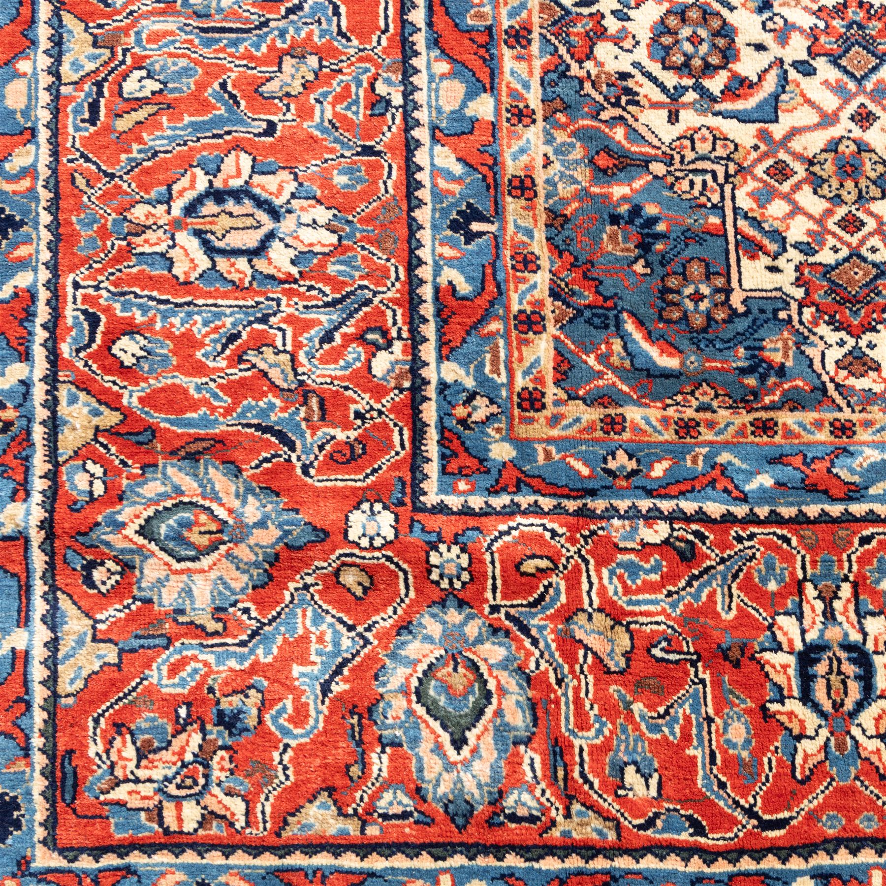 Large West Persian Bidjar hand-knotted carpet, deep indigo field with central medallion with pendants issuing an all-over design of scrolling vines, palmettes, and floral sprays, within conforming spandrels, enclosed a broad madder red palmette, and vine border framed by guard stripes, in a palette, of indigo, madder red and ivory tones, with cotton fringe ends 