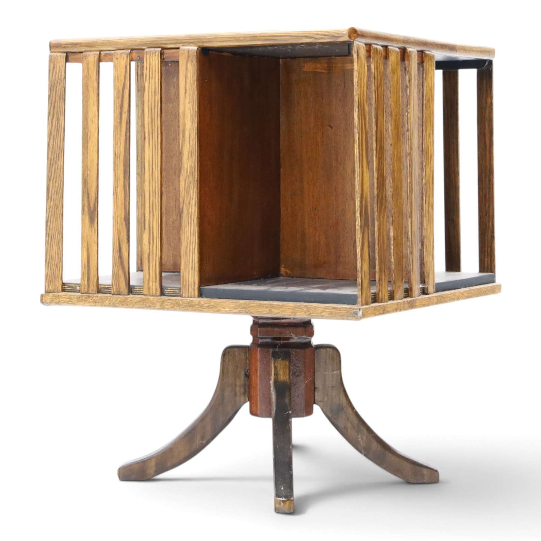 Early 20th century oak revolving bookcase, square top above four divided sections, raised on a revolving base