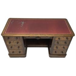 Victorian figured walnut kneehole desk, moulded rectangular top with inset leather writing surface, fitted with nine drawers, the central frieze drawer with carved curled foliage mount, on moulded plinth base,