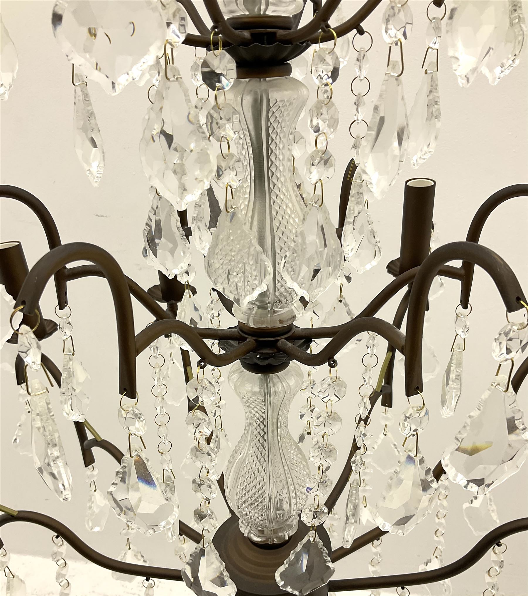 Contemporary bronze finish twelve branch chandelier, decorated with glass droplets 