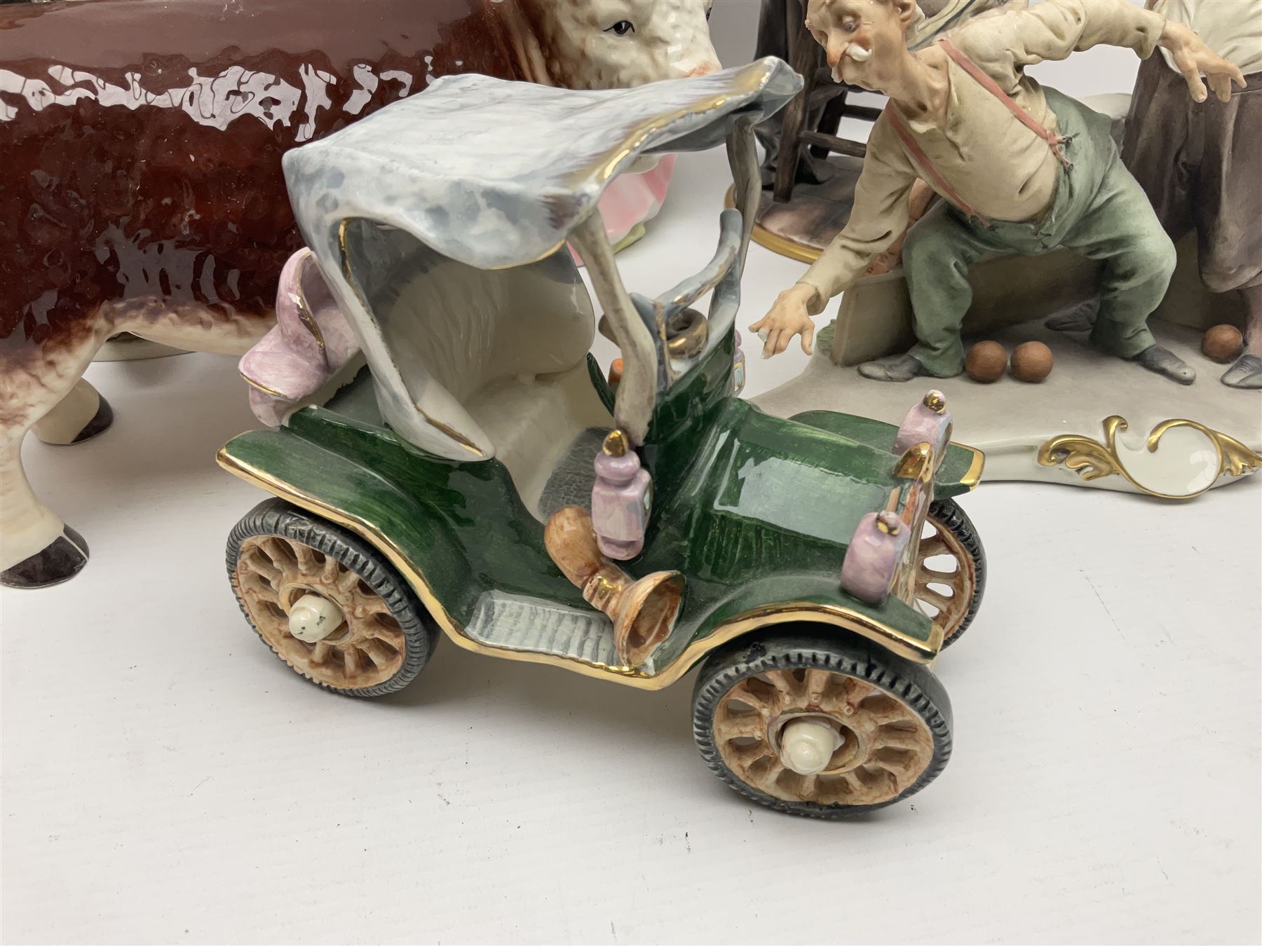 Two Capodimonte figures together with Melba Ware bull and other ceramics 