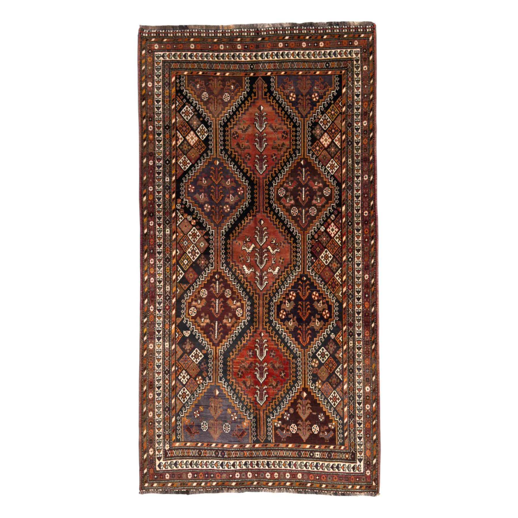 Southwestern Persian Qashqai hand-knotted carpet, the field with a lattice of hexagonal medallions in rust, indigo, and ochre, each containing stylised tree and floral motifs, flanked by lozenge panels with geometric designs, enclosed by multiple borders with rosettes and leaf motifs