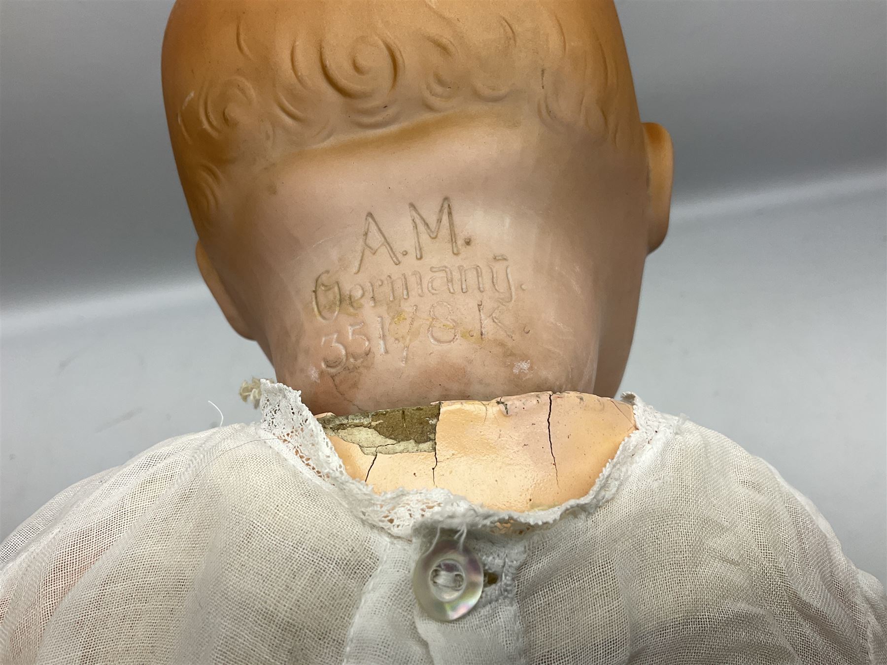 Heubach Koppelsdorf Germany bisque head doll with applied hair, sleeping eyes, open mouth with teeth and composition body with jointed limbs; marked 'Heubach Koppelsdorf 342.6/0 Germany' H34cm; Armand Marseille bisque head baby doll with moulded hair, sleeping eyes, open mouth and composition body with jointed limbs; marked 'A.M. Germany 351./8.K.; and BND London all composition doll (3)