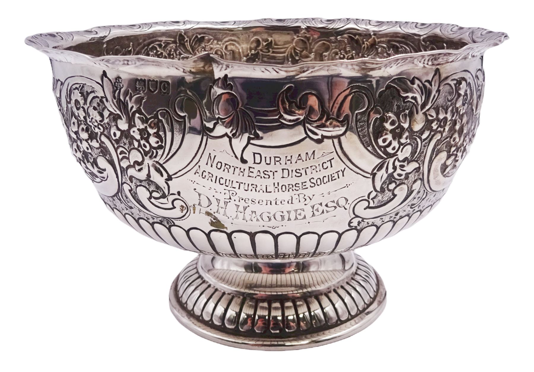 Late Victorian silver rose bowl, of circular form with embossed foliate and C scroll decoration, and engraved personal dedication, upon a part fluted spreading circular foot, hallmarked Wakely & Wheeler, London 1898, H11.5cm D18cm, approximate weight 11.67 ozt (363.2 grams)