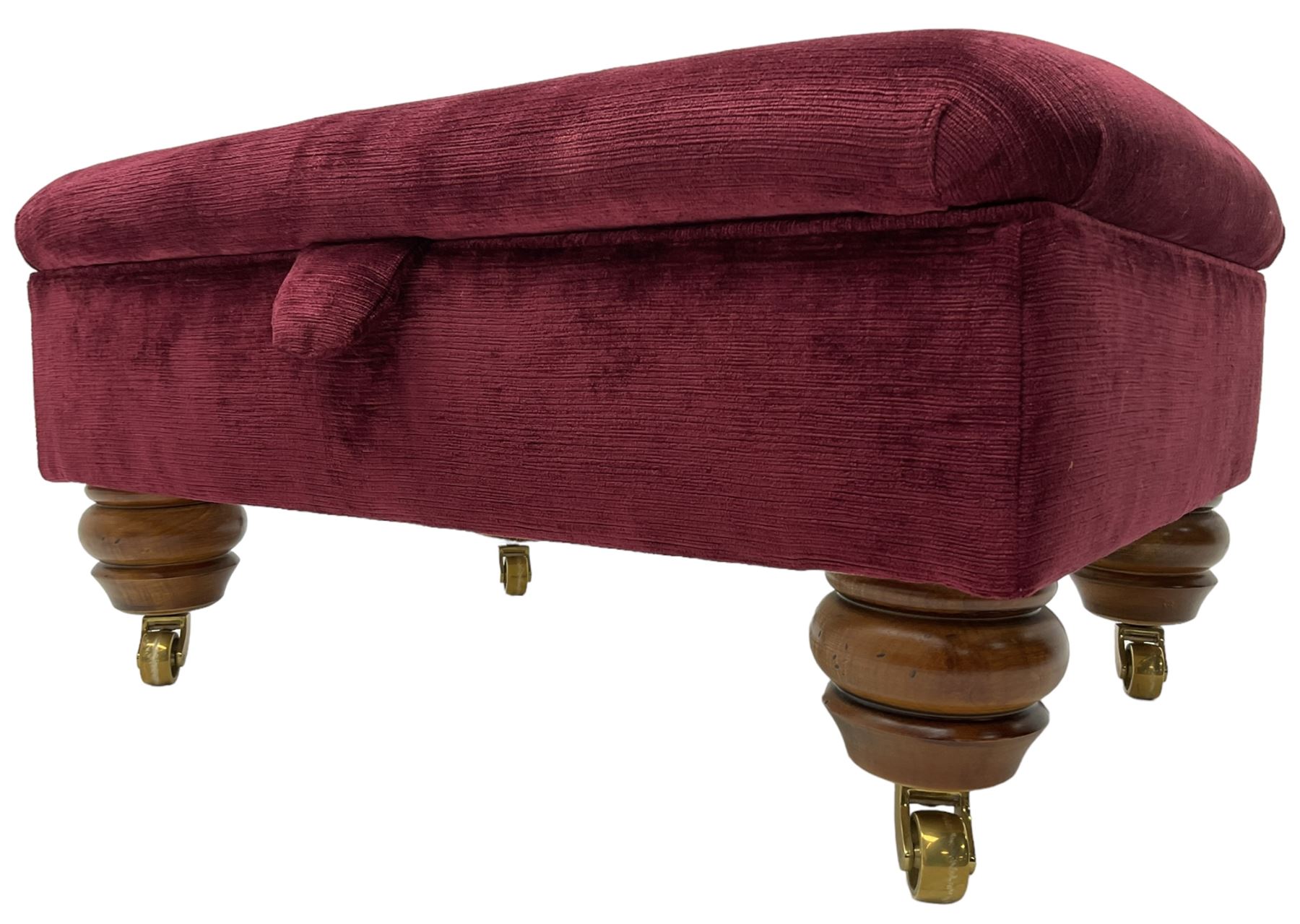 Duresta - traditional shape armchair upholstered in burgundy red velvet, on square tapering front supports (W88cm, H85cm, D103cm); together with a matching rectangular footstool with hinged seat, on turned feet with brass castors (73cm x 54cm, H38cm)