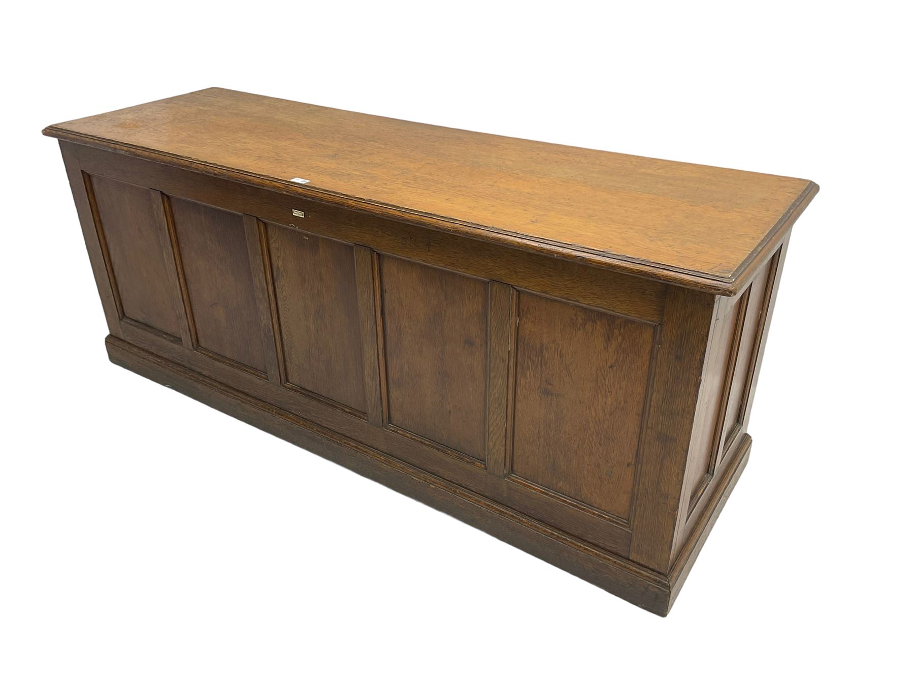 Illingworth Ingham and Co. School Furnishers (Leeds c1900) - early 20th century oak rostrum or headmaster's desk, rectangular top, the front and sides panelled with open reverse, on plinth base