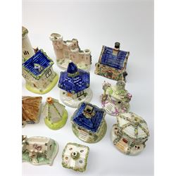 A collection of various 19th century Staffordshire pastille burners modelled in the form of buildings, together with other models of buildings, a number of later similar examples, plus an early 19th century Prattware money box, (a/f). (16). 
