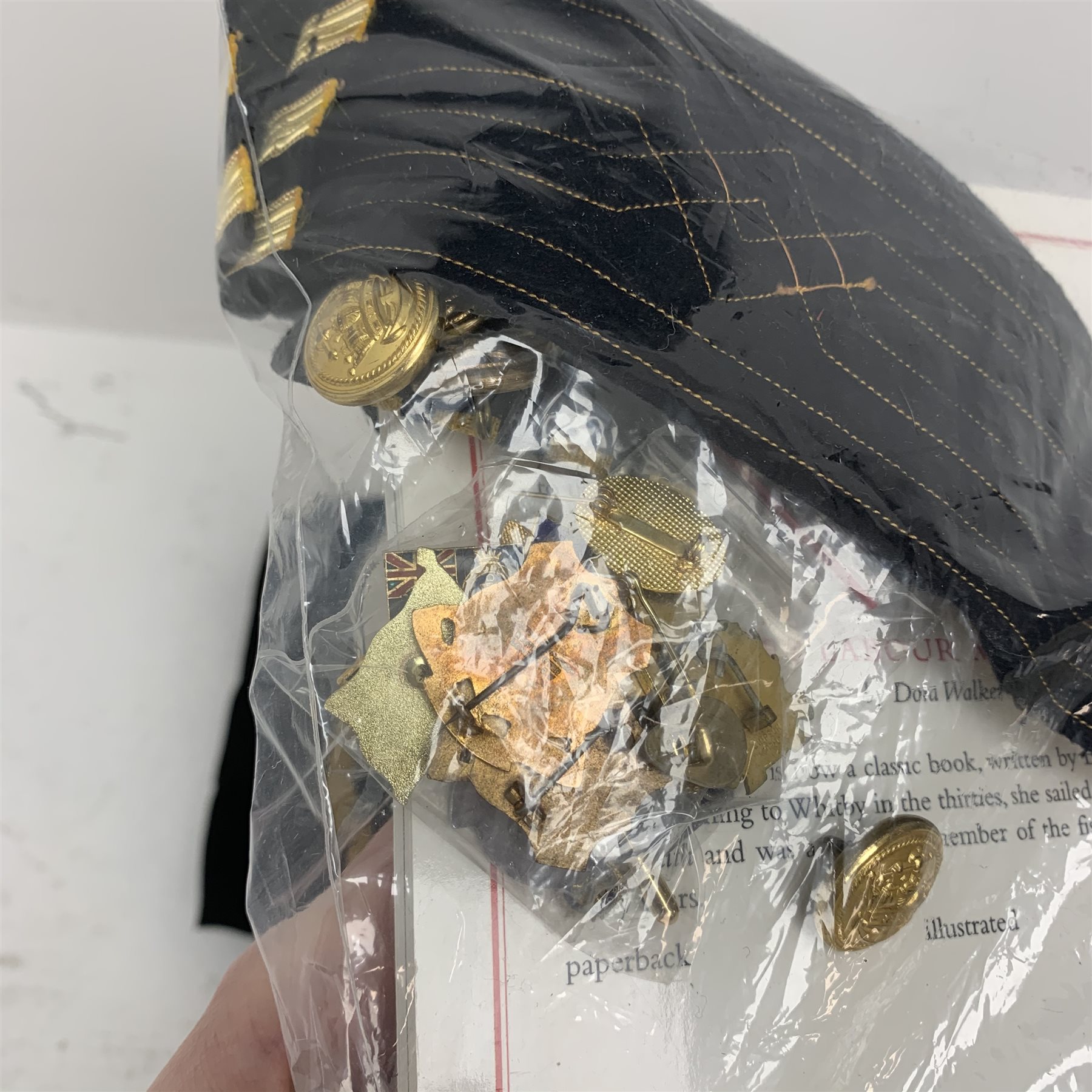Merchant Navy captain's uniform with WW2 medal ribbons and peaked cap, epaulettes, spare cuff braiding, quantity of buttons and metal badges and two books of maritime interest