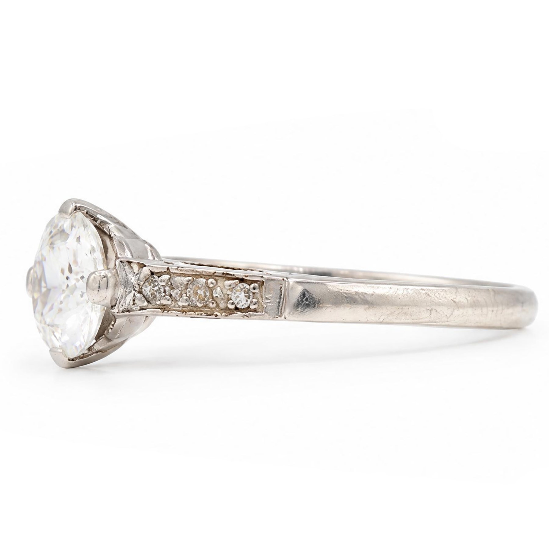 Early 20th century platinum diamond ring, four claw set with a single old cut diamond of approx 0.90 carat and diamond set shoulders, stamped Plat, inscribed with initials and dated 7.6.28