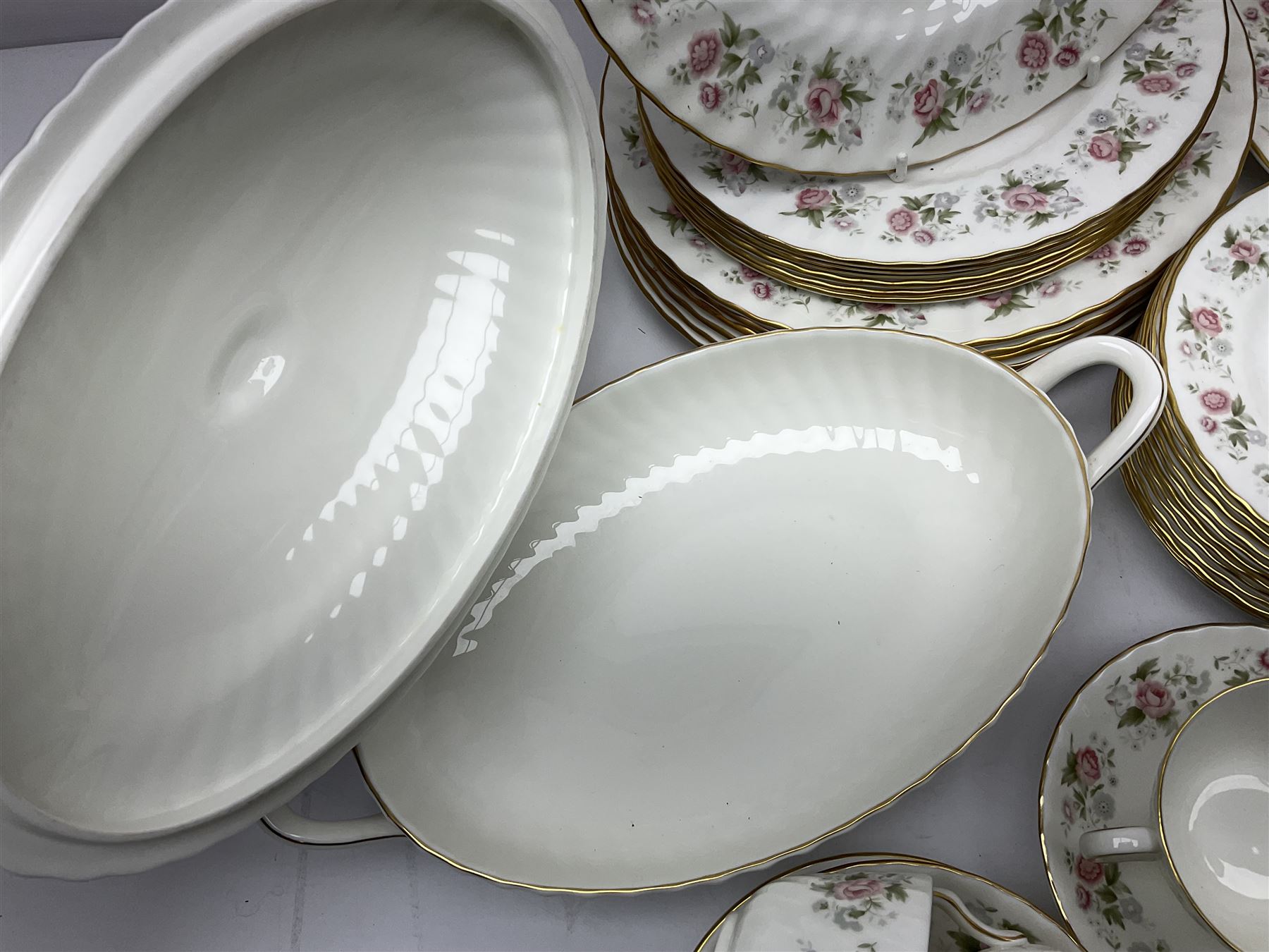 Minton Spring Bouquet pattern dinner and tea service, comprising dinner plates, twin handled tureens with covers, meat platter, teapot, milk jug, sugar bowl with cover, tea cups and saucers, bowls, cake plate, side plates, dessert plates, etc all with printed mark beneath (82)