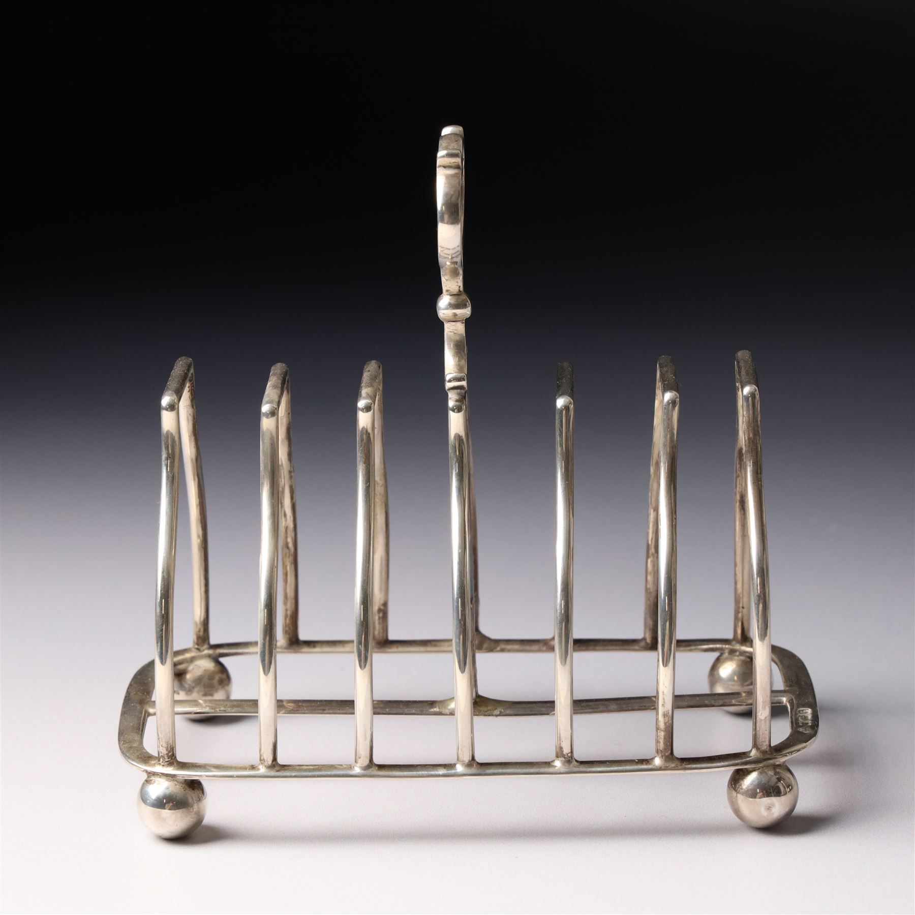 Edwardian silver six division toast rack with loop handle and ball feet Sheffield 1908 Maker Martin Hall & Co