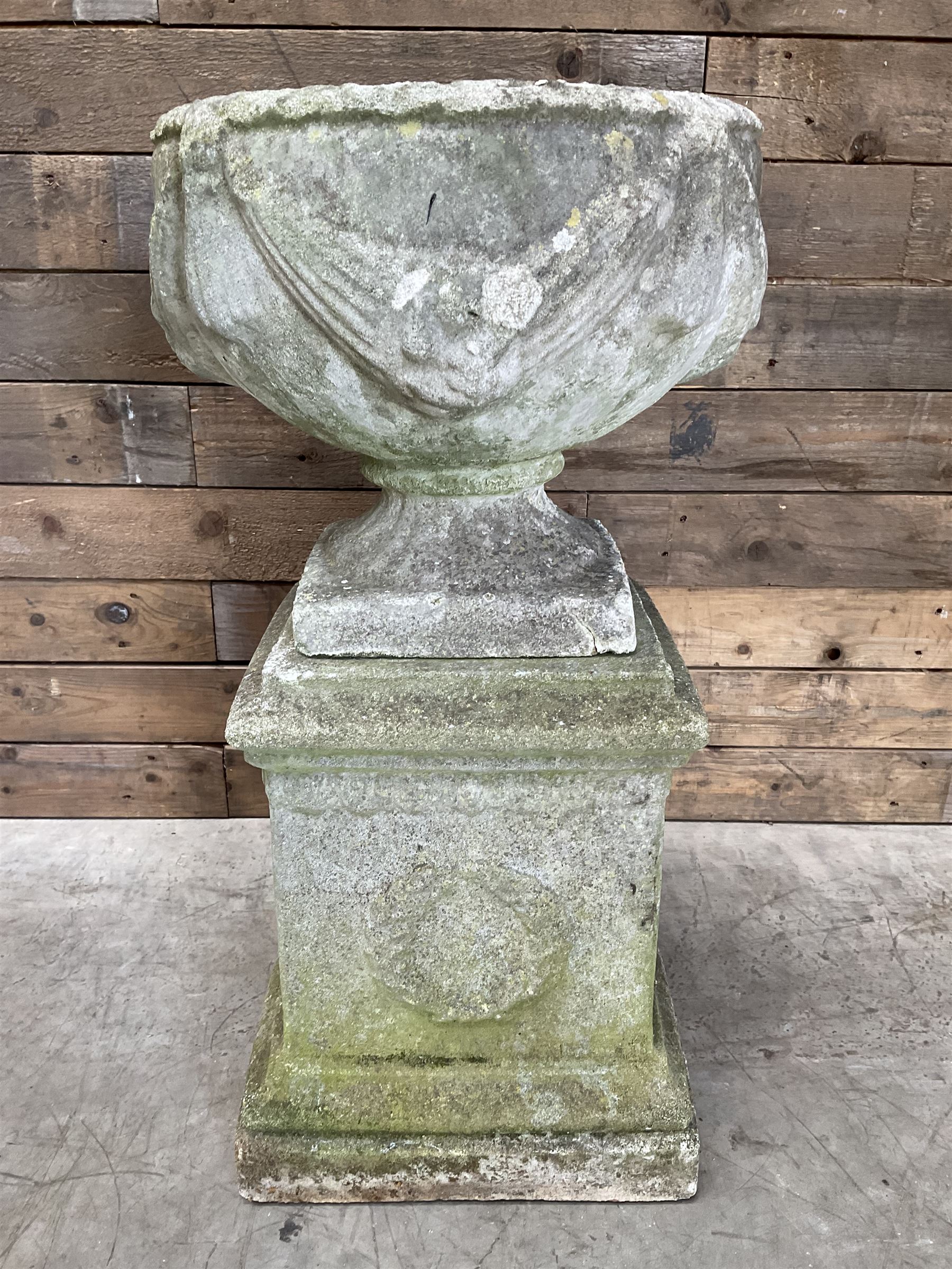 Cast stone centerpiece urn on plinth