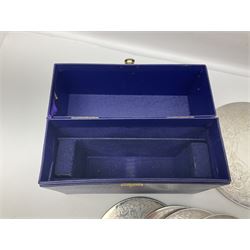 Set of eight silver plated placemats, each of circular form with engraved scroll and floral decoration, including two larger and six smaller examples, largest D23cm, in fitted case 