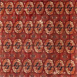 Persian Bokhara crimson ground rug, the field decorated with five rows of repeating Gul motifs with interspersed geometric design, enclosed by a guard band of further geometric-style Gul designs comprised of hook motifs
