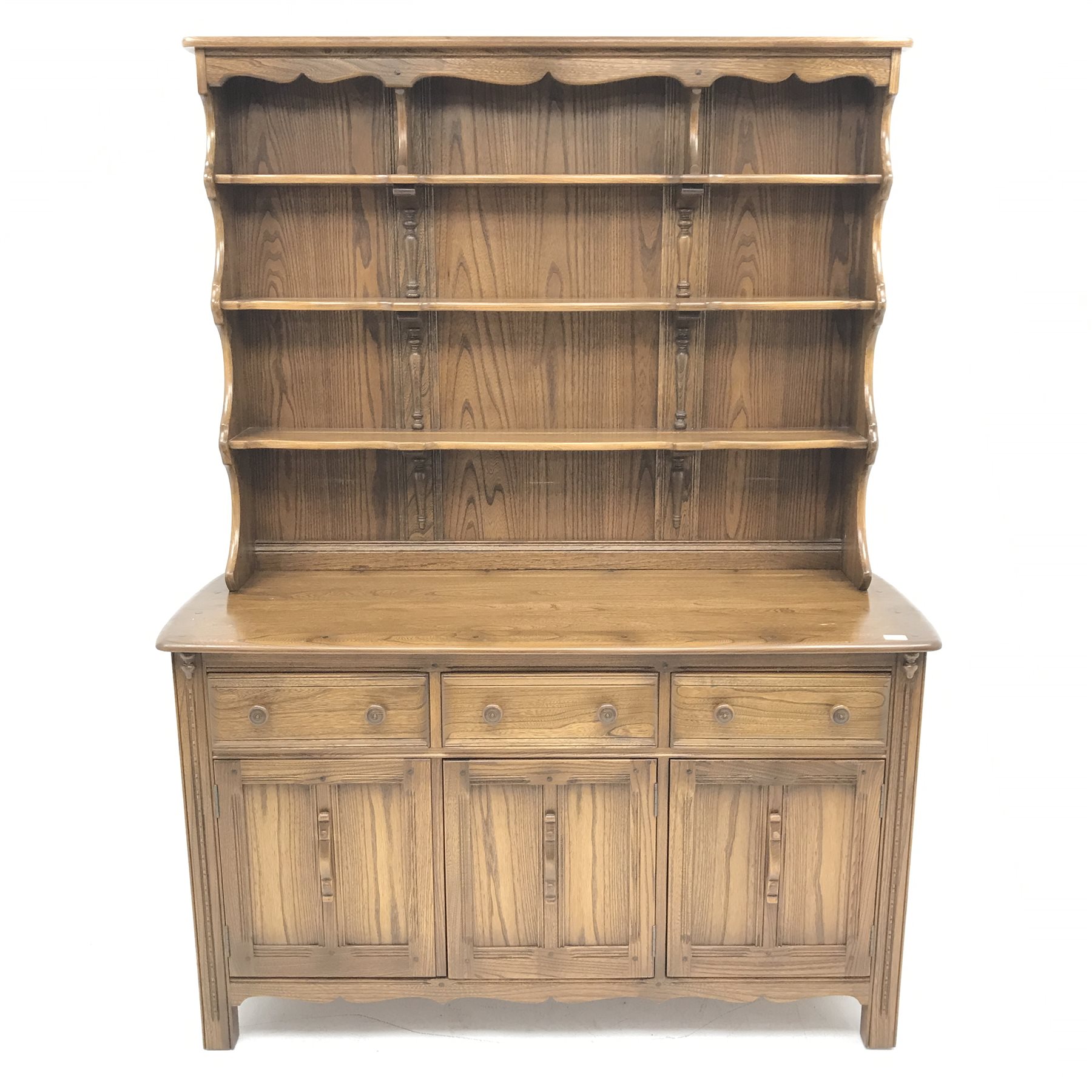 Ercol Old Colonial elm dresser, Golden Dawn finish, raised three tier plate rack above three drawers and three cupboards, stile supports, W147cm, H193cm, D52cm