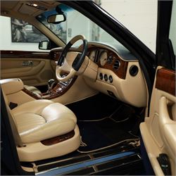 2001 Bentley Arnage Red Label Saloon

Registration: BU51 TGX
Engine: 6.75-litre turbocharged V8 petrol
Transmission: Automatic
Odometer reading: 39,942 miles
Colour: Black Sapphire metallic
Interior: Magnolia leather with burr walnut veneers
Previous owners: 3
V5C: Present
Service history: Good service records

An exceptional Bentley Arnage Red Label Saloon, finished in Black Sapphire metallic, a very dark blue, with a Magnolia leather interior, contrasting dark blue carpets and extensive burr walnut veneers. The car displays an odometer reading of approximately 39,942 miles.

The Arnage Red Label combined Bentley’s renowned 6.75-litre turbocharged V8 engine with automatic transmission, delivering effortless performance in a traditionally appointed luxury saloon. The model is distinguished by its imposing proportions, characteristic Bentley radiator grille and finely crafted interior.

Presented in excellent condition throughout, the bodywork and metallic paint finish appear particularly well preserved, complemented by clean brightwork and the correct Bentley alloy wheels. The engine bay is also notably well detailed.

The interior presents exceptionally well, retaining its Magnolia leather upholstery, polished burr walnut veneers, original factory instrumentation and switchgear. The leather displays only light creasing consistent with careful use.

The car has had three previous owners and is accompanied by good service records.

Features

• 6.75-litre turbocharged V8 petrol engine
• Automatic transmission
• Black Sapphire metallic paintwork
• Magnolia leather interior
• Contrasting dark blue carpets
• Burr walnut veneers
• Electrically adjustable front seats
• Air conditioning
• Factory instrumentation and switchgear
• Bentley alloy wheels
• Right-hand drive
• Odometer reading of approximately 39,942 miles
• Three previous owners
• Good service records
• V5C present

This vehicle forms part of the Estate of the Late John Sills and is offered for sale by the Executors, confirming a genuine reason for sale.
