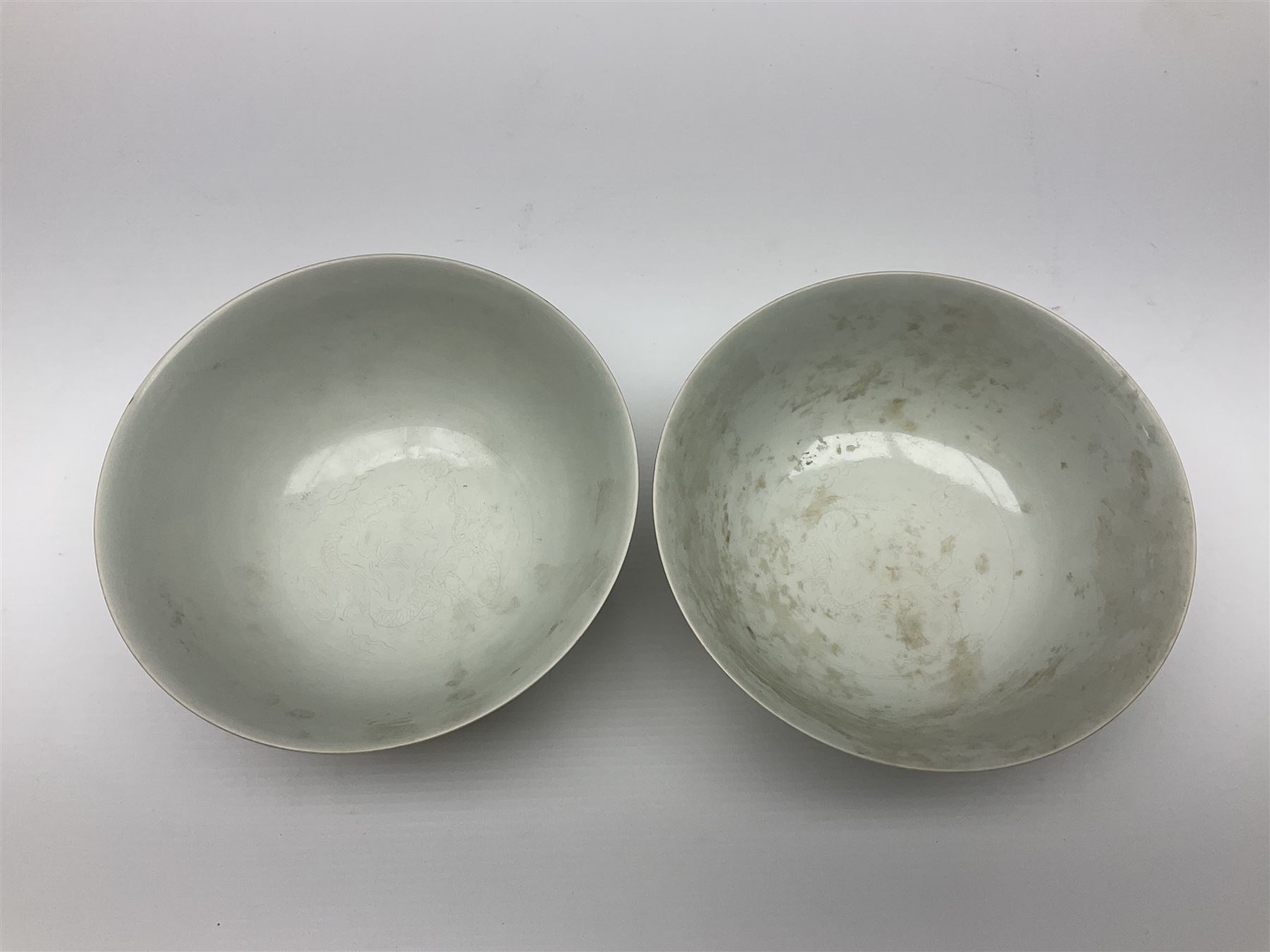 Pair of Chinese famille jaune bowls, decorated in green enamel with a dragon chasing a flaming pearl amongst clouds, upon a yellow ground, the interior decorated to centre with dragon, with six character mark beneath, D17.5cm