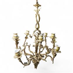 Rococo design brass ten light chandelier with scroll branches and ceramic candle holders H74cm