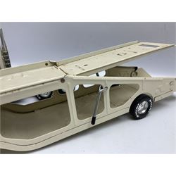 American Nylint large scale tin-plate car transporter L59cm carrying a Testor Toys plastic car; Tonka tin-plate mobile crane; boxed Sarony Cigarettes tin-plate roulette game with rules; and Japanese style tin-plate box, the lid inset with a revolving poker dice game (4)