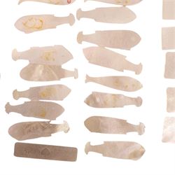 Collection of approximately sixty mother-of-pearl gaming tokens, including fish-shaped, rectangular, circular examples 