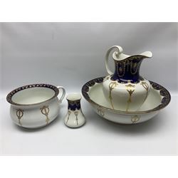 Early 20th century Bishop and Stonier four piece toilet set, comprising washbowl, wash jug, toothbrush pot, and chamber pot, each  decorated with deep blue band and husk swags and festoons in gilt, with printed Caduceus Bisto marks beneath and printed retailers mark 'Manufactured for Harrods Limited London', wash bowl D43cm, wash jug H31.5cm
