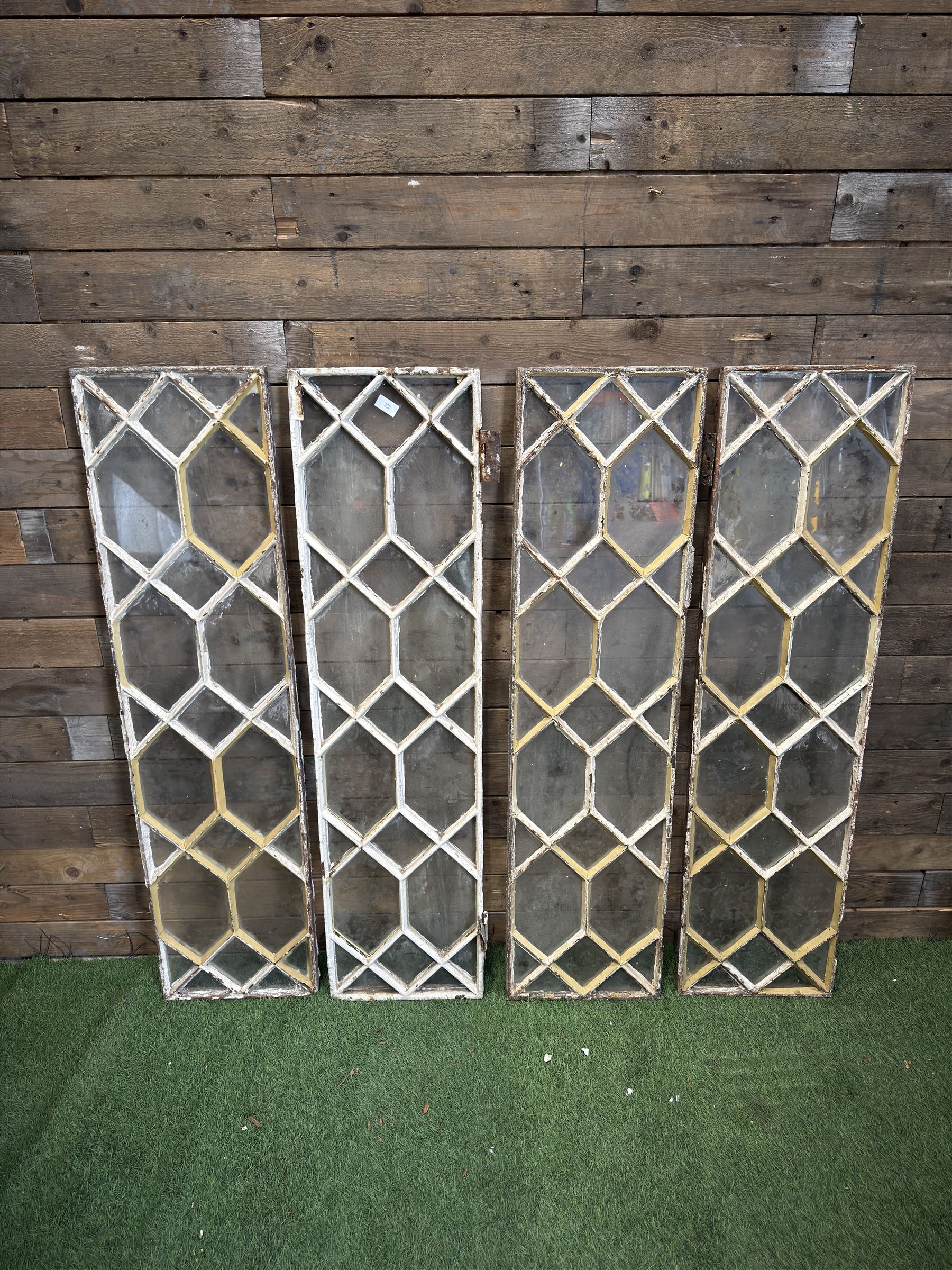 Four 19th century cast iron windows, lattice glazed in white painted finish, 