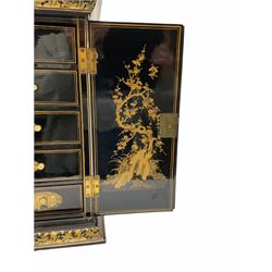 Early 20th century Oriental black lacquered chest of small proportions, fronted by double doors concealing six drawers with ivory handles, decorated in gilt with figures and buildings, H42.5