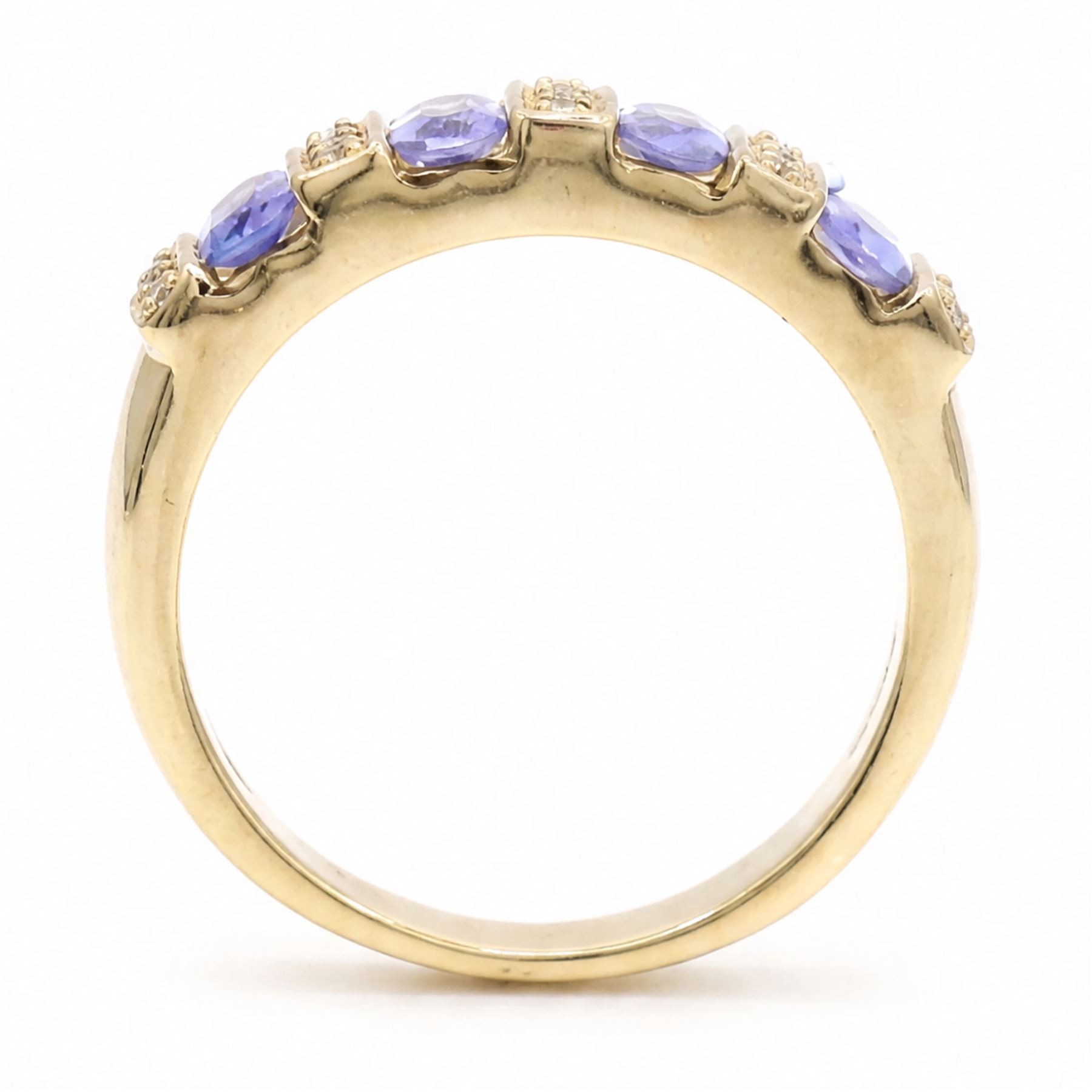 9ct gold tanzanite and diamond half eternity ring, four oval cut tanzanite's, each spaced by three single cut diamonds, hallmarked