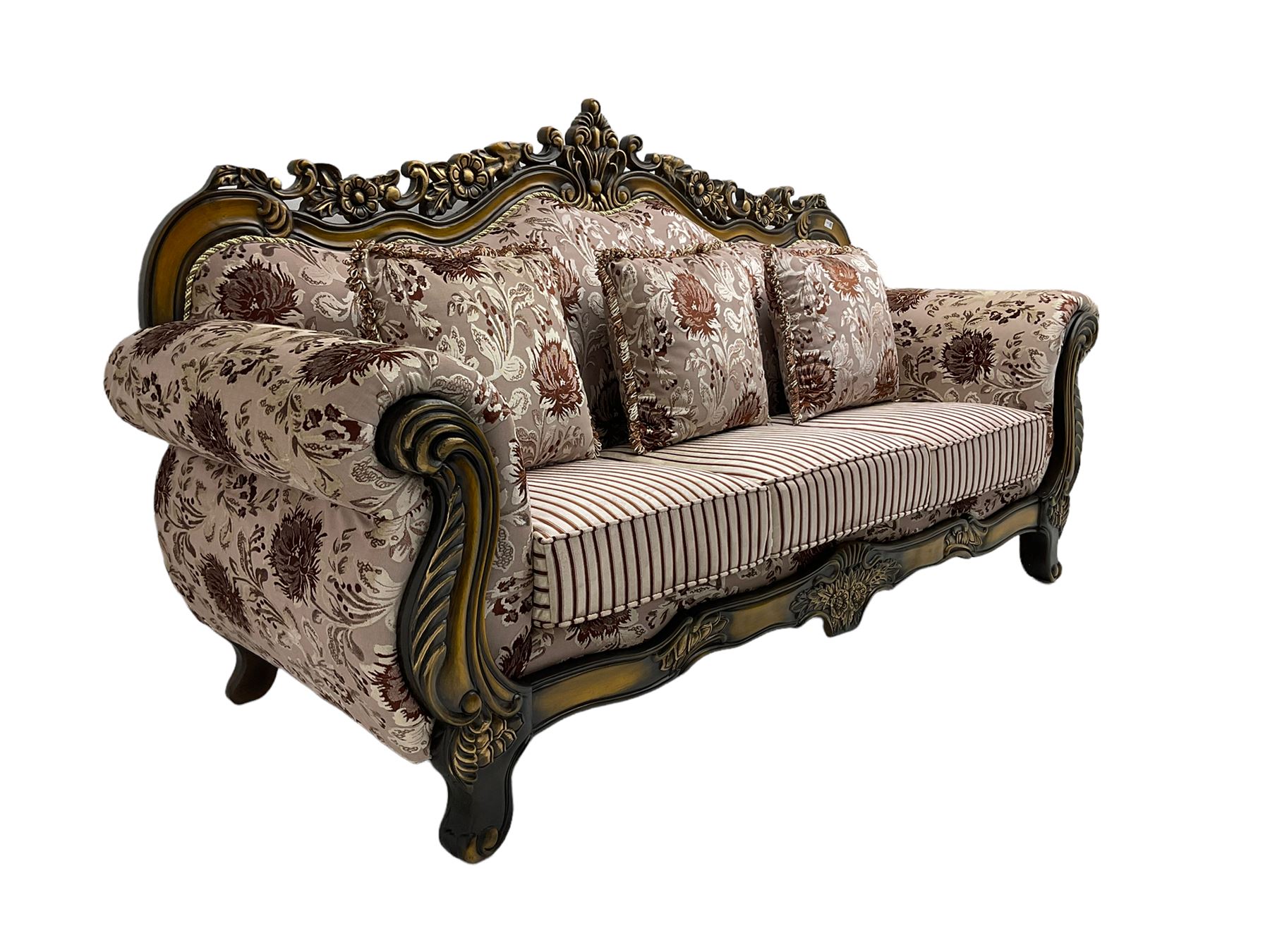 Italian Baroque design three seat sofa, hardwood framed, the cresting rail carved and pierced with c-scrolls and flower heads, scrolled arms, upholstered in floral patterned and striped fabric, with scatter cushions 