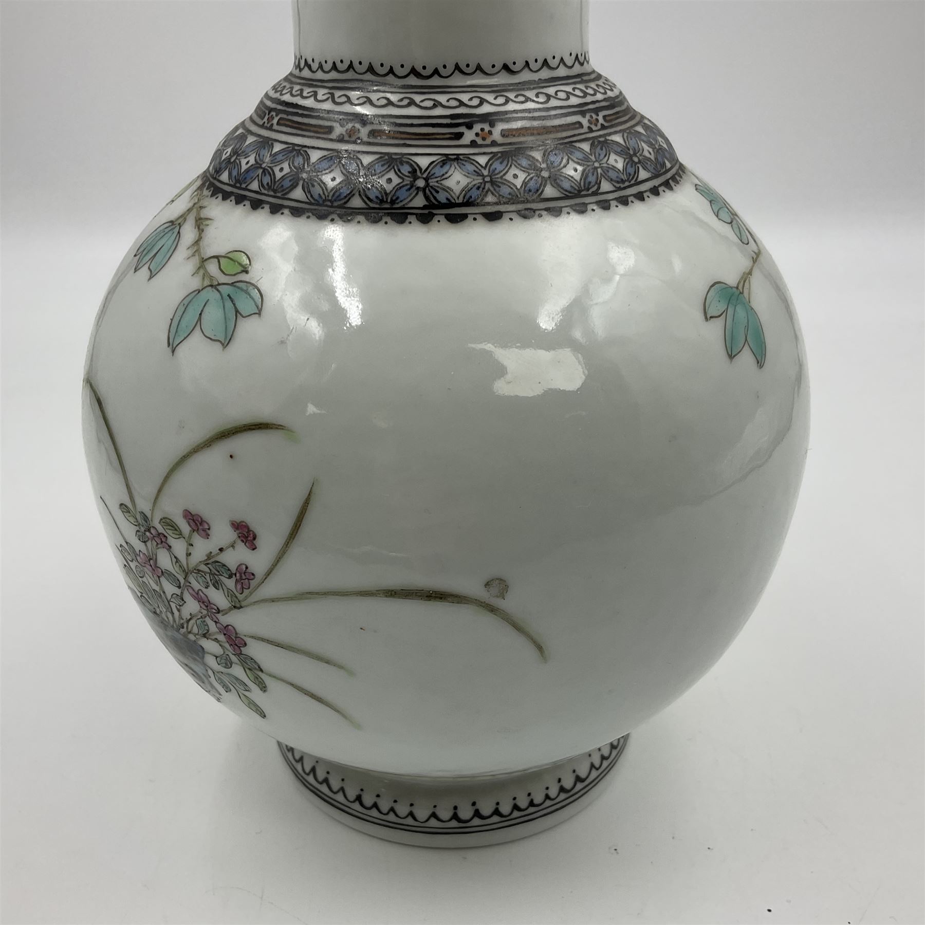 Pair of Chinese Republic porcelain vases, each painted in Famille Rose enamels with pairs of pigeons amidst peony, rock, flowering plants and leafy branches, possibly Qianlong seal beneath, H22cm 