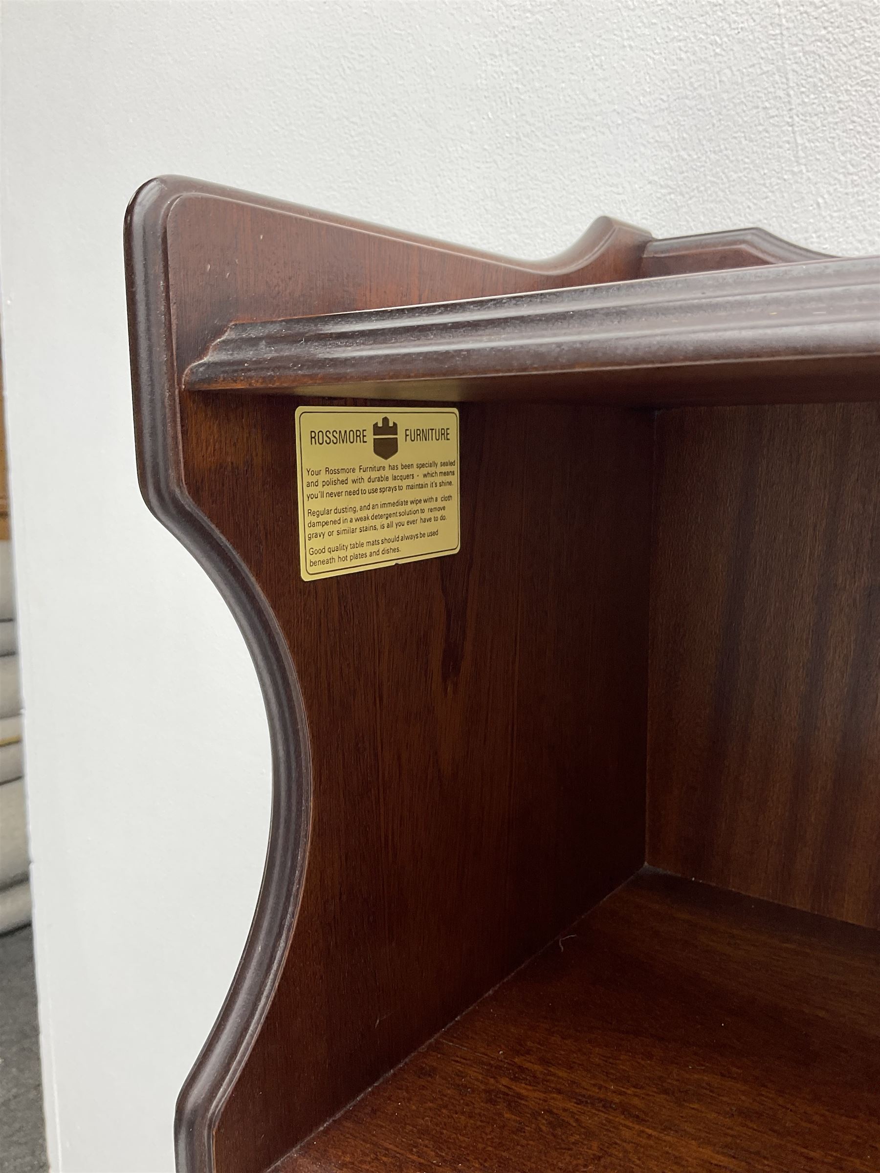 Rossmore Furniture - mahogany bookcase fitted with four shelves, shaped end supports