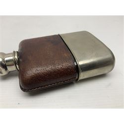 Silver plated glass and pressed leather hip flask, with swivel cap and removable cup, together with a similar oval example, engraved with wreath and initial B, tallest H16.5cm