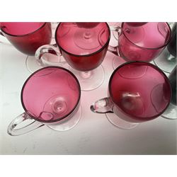 Collection of 19th century coloured glasses, to include nine cranberry glass punch cups, each with clear glass handle and foot and a set of six green glasses, with short clear stems, tallest H10cm
