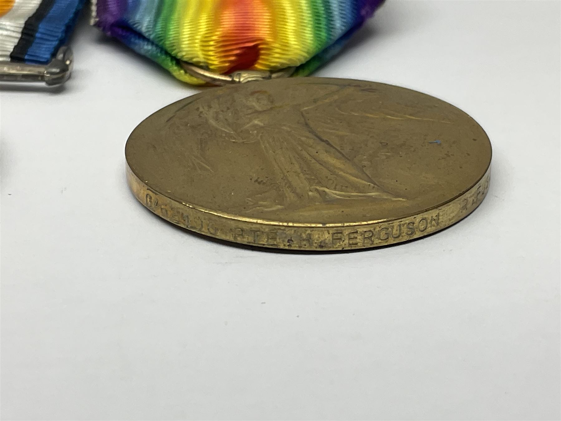 WWI pair of medals comprising British War Medal and Victory Medal awarded to G/62196 Pte. H. Ferguson R. Fus. with ribbons on wearing bar; together with bronze memorial plaque to Henry Ferguson (3)
