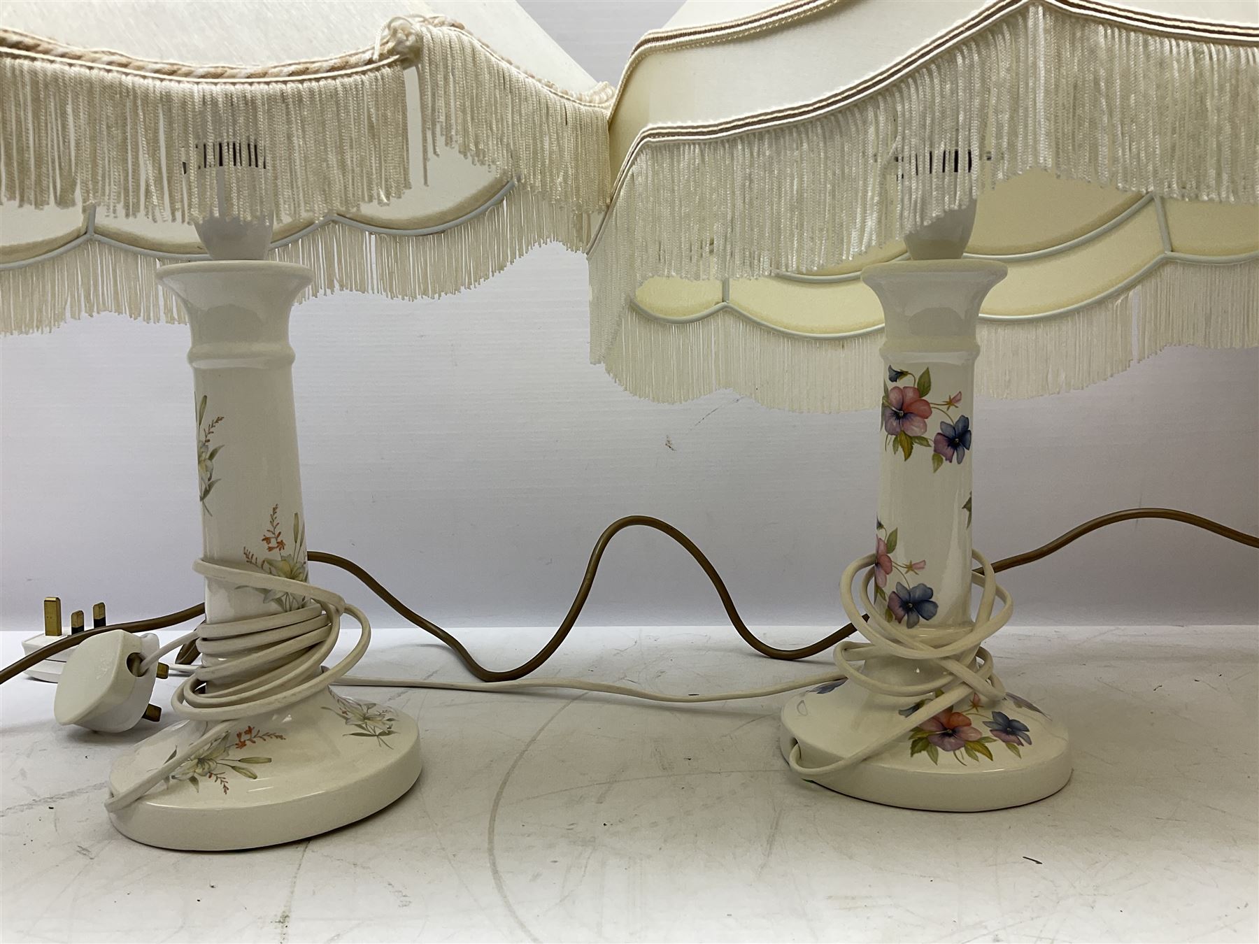 A Belcari figural table lamp, modelled as a young gent leaning upon brick wall, on turned wood base, signed, H70cm incl shade, together with bronzed figural table lamp of a lady with parasol upon ornate circular plinth base, two ceramic table lamps and another lamp (5)