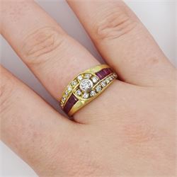 18ct gold diamond and ruby crossover ring, the principal round brilliant cut diamond of approx 0.10 carat, with graduating round brilliant cut diamond and calibre cut ruby shoulders, stamped 750