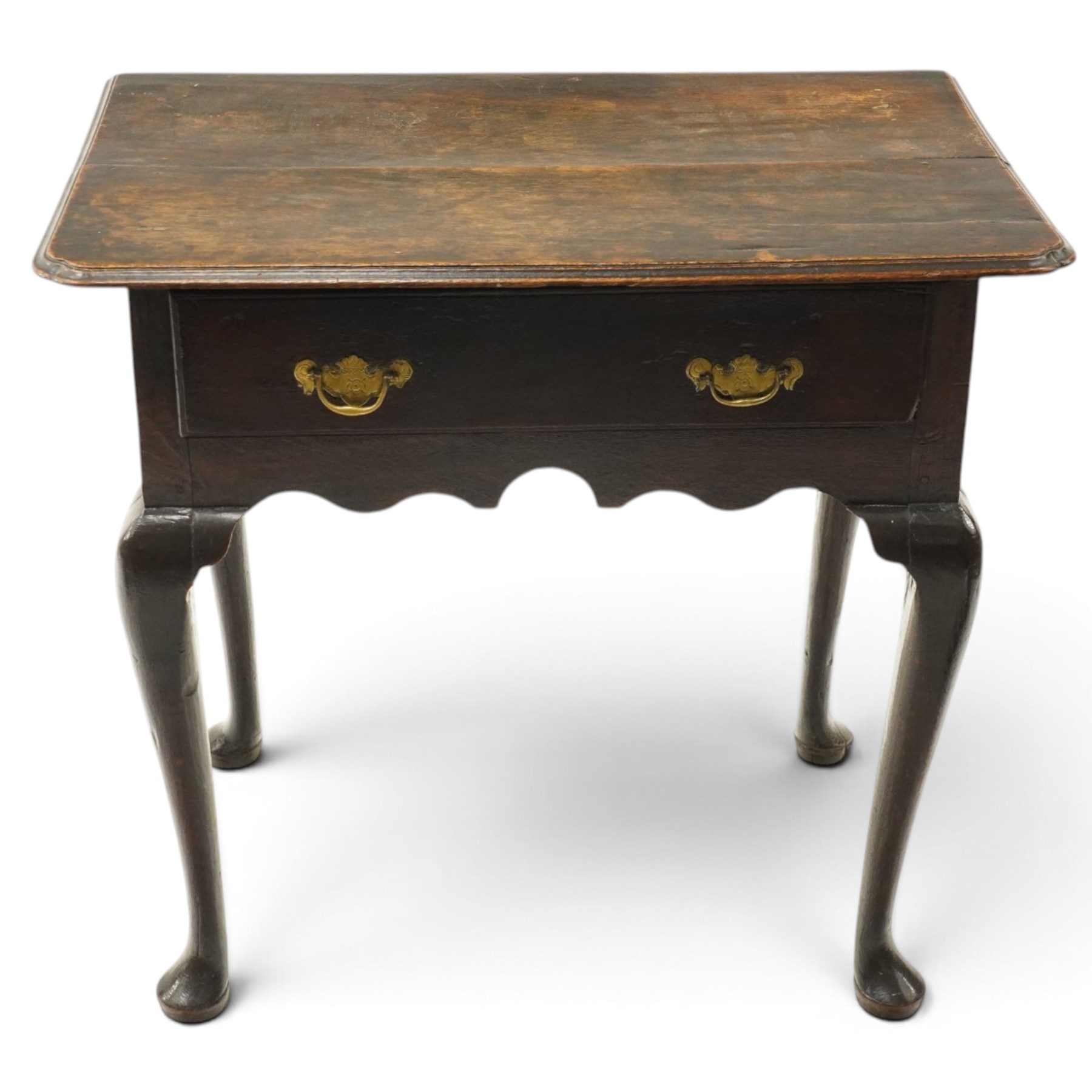 18th century oak lowboy, the rectangular top with moulded edge and eared front-corners, fitted with single drawer with pressed brass handle-plates, shaped apron over cabriole supports and pad feet