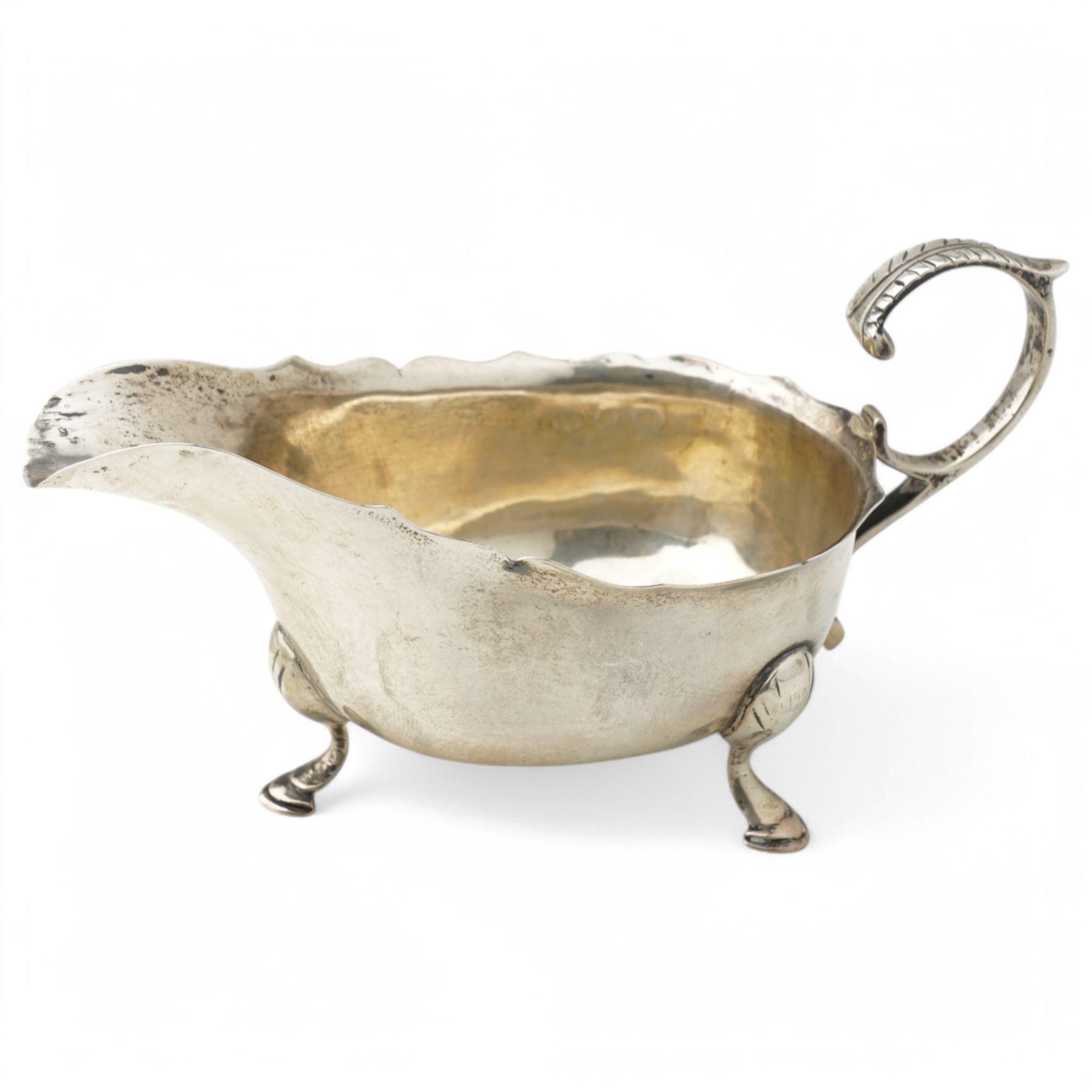 George III silver cream jug with gadrooned edge and leaf capped handle on shaped supports London 1817 Maker Robert Peppin and a small Victorian silver sauce boat with crimped rim Birmingham 1893 Maker Thomas Hayes (2)