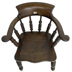 Early 20th century stained beech captains smokers bow chair, spindle tub shaped back over saddle seat, raised on turned supports united by double H-stretcher