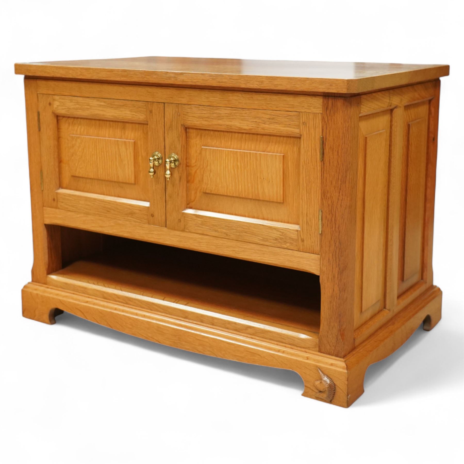 Unicornman - Yorkshire oak media cabinet, rectangular top over a pair of panelled cupboard doors with brass handles, open undertier, on shaped bracket supports above castors