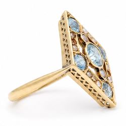 Early 20th century gold blue stone and split pearl diamond shaped ring, five milgrain set round cut stones possibly zircon or aquamarines, with seed pearl surround in a pierced design setting, stamped 18ct 