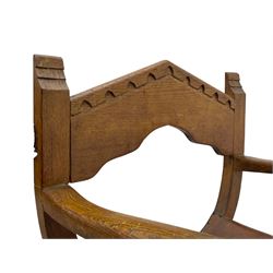 'Gnomeman' oak curved x-framed throne chair, sloped arched cresting rail carved with arcade, studded slung leather seat, the supports joined by sledge feet, rear upright carved with gnome signature, by Thomas Whittaker of Littlebeck
