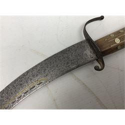 Late 19th/early 20th century Moroccan nimcha dagger-sword, the 40cm curving steel blade with engraved decoration on both sides; shaped hardwood hilt inlaid with brass, white metal wires and red coloured panels; in similarly inlaid scabbard L61cm overall