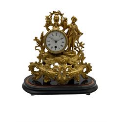 A late 19th century French 8-day timepiece mantle clock in a spelter case on an ebonised oval plinth, with a white enamel dial, Roman  numerals and minute markers, steel spade hands with an unglazed beaded bezel, the spring driven drum movement housed in a gilt spelter rococo designed case with a figure of a young gallant.
With pendulum, no key.
