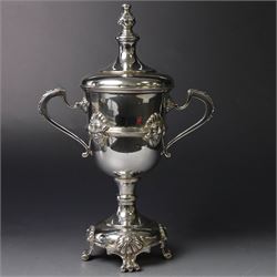 Mid 20th century silver twin handled trophy cup and cover, the bowl with central mask mounted girdle upon a knopped stem and spreading circular foot with flower head mounted paw feet, the tapering stepped cover with leaf moulded knop finial, hallmarked Vaughton & Sons, Birmingham 1938