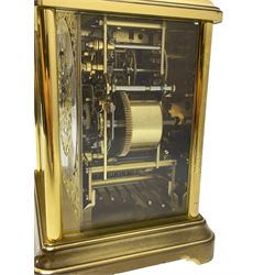 A 20th century brass cased Kieninger (German) chiming mantle clock with a break arch top and three glazed panels, polished sheet brass dial with applied  brass fretwork and a silvered chapter ring, Roman numerals, minute track, steel serpentine hands and seconds dial, three-train spring driven 8-day movement with Westminster, St Michael and Whittington chimes on 8 gong rods, 9 jewel lever platform escapement.  With key. 