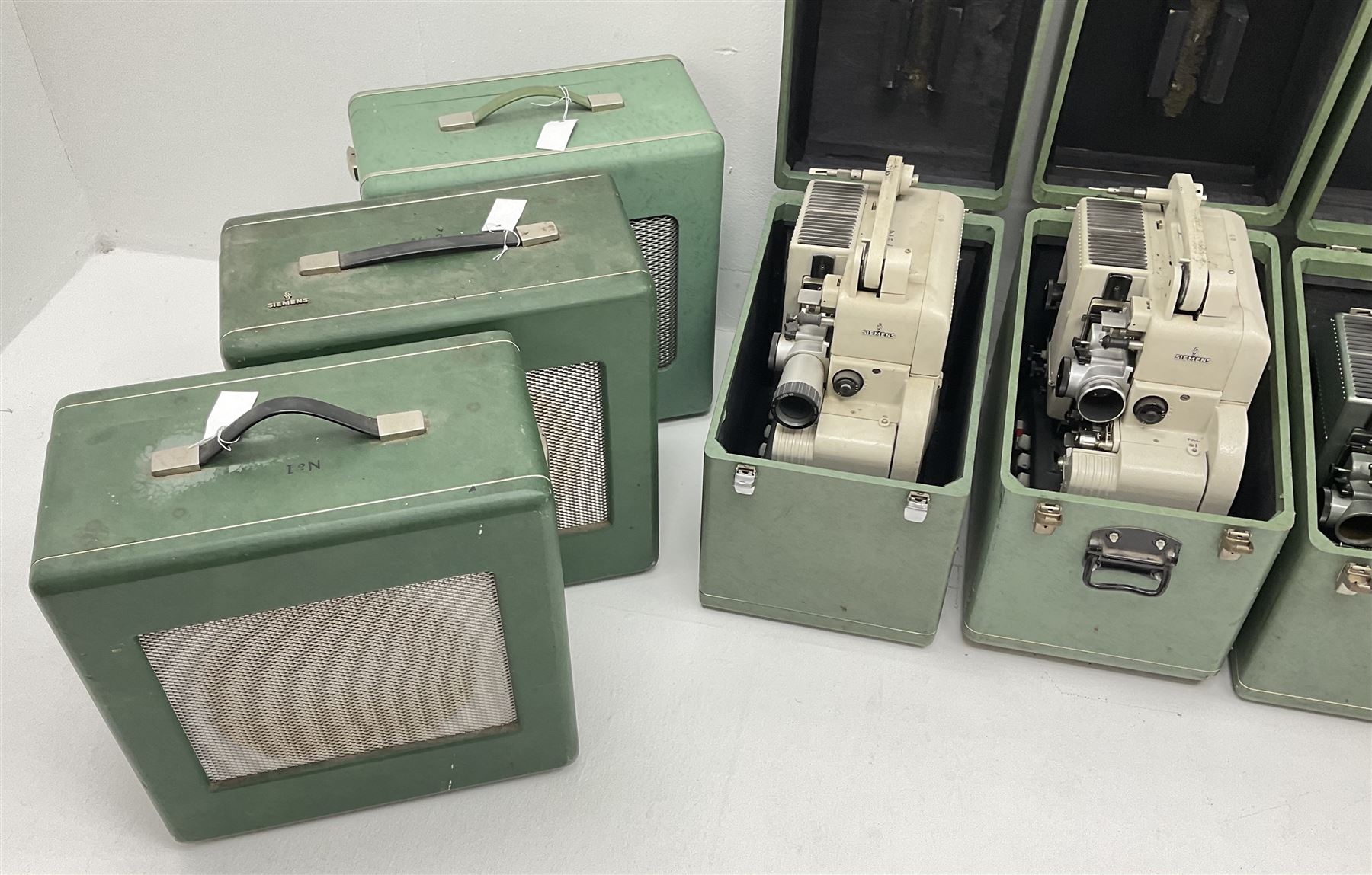 Group of vintage Siemens projectors and various speakers, all housed in